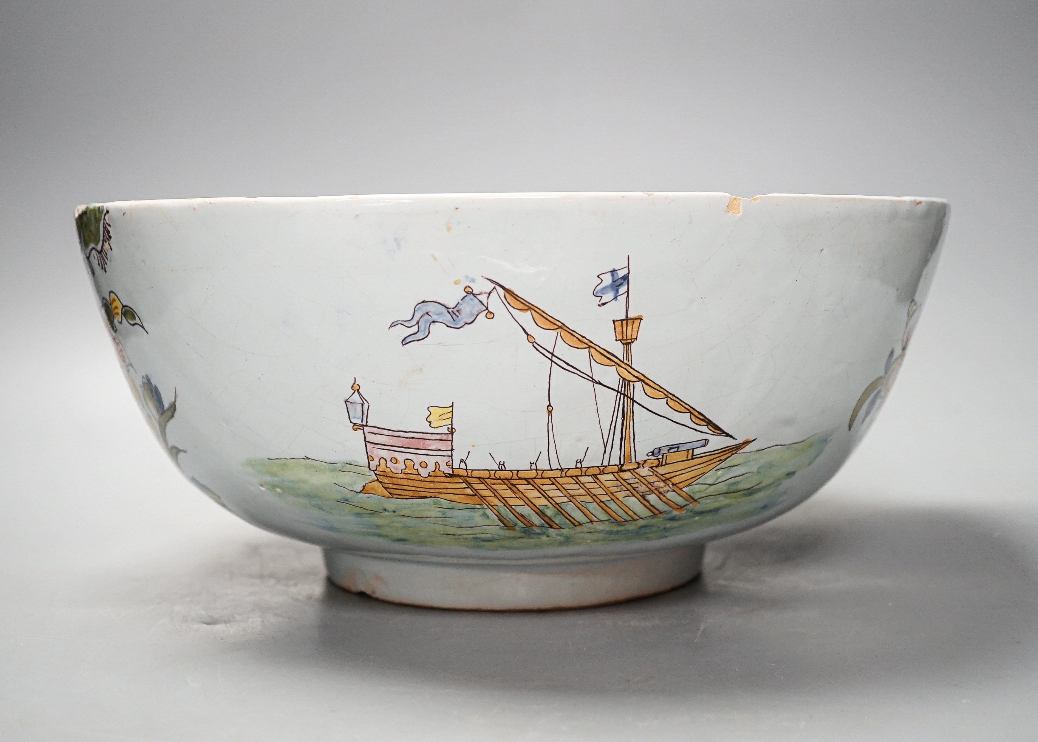 Lord Admiral Nelson. A commemorative Delftware punch bowl, 19th century, painted in polychrome with a portrait of Nelson, as hip and floral sprays, D. 30cm, splinter chip to edge
